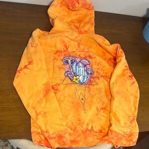 Vibrant Orange Hoodie with Artistic Design